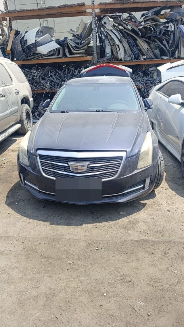 Dark grey Cadillac ATS sedan for parts — hood, chrome grille, headlights and front bumper, Sharjah market