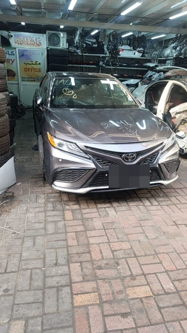 Dark grey Toyota Camry halfcut front view — bumper, grille, headlights and hood, Sharjah market