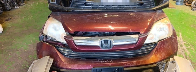 Dark red Honda CR-V halfcut front with hood, headlights, chrome grille and bumper, Sharjah market