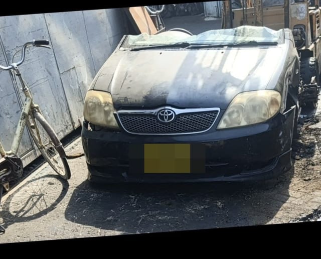 Black Toyota Corolla sedan front halfcut with bumper, grille, headlights and hood, Sharjah market