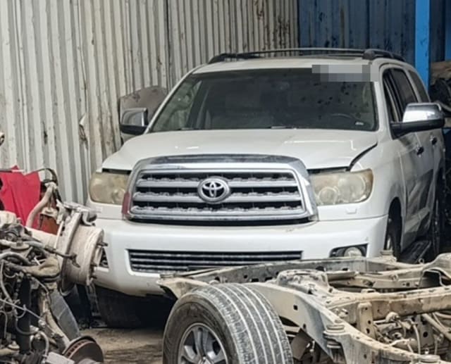 White Toyota Sequoia SUV for parts: chrome grille, bumper and headlights, Sharjah market