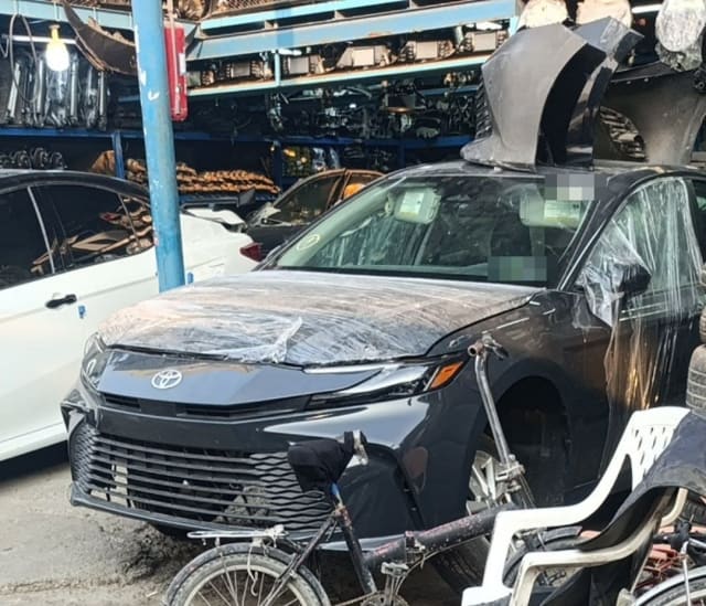 Black Toyota Camry halfcut, front bumper, grille, LED headlights and wrapped hood, Sharjah parts market