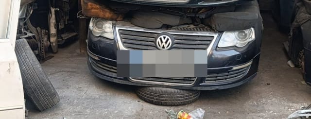 Dark Volkswagen Passat front halfcut — bumper, chrome grille and headlights, Sharjah market