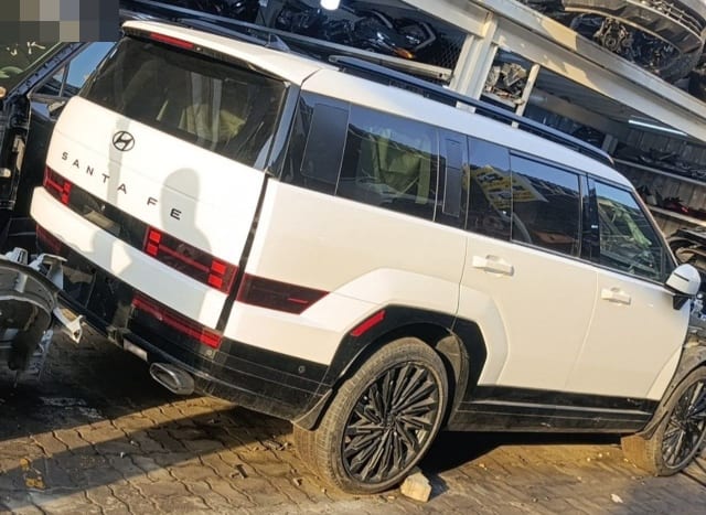 White Hyundai Santa Fe SUV for parts, rear-side view: tailgate, LED taillights, doors and alloy wheels, Sharjah