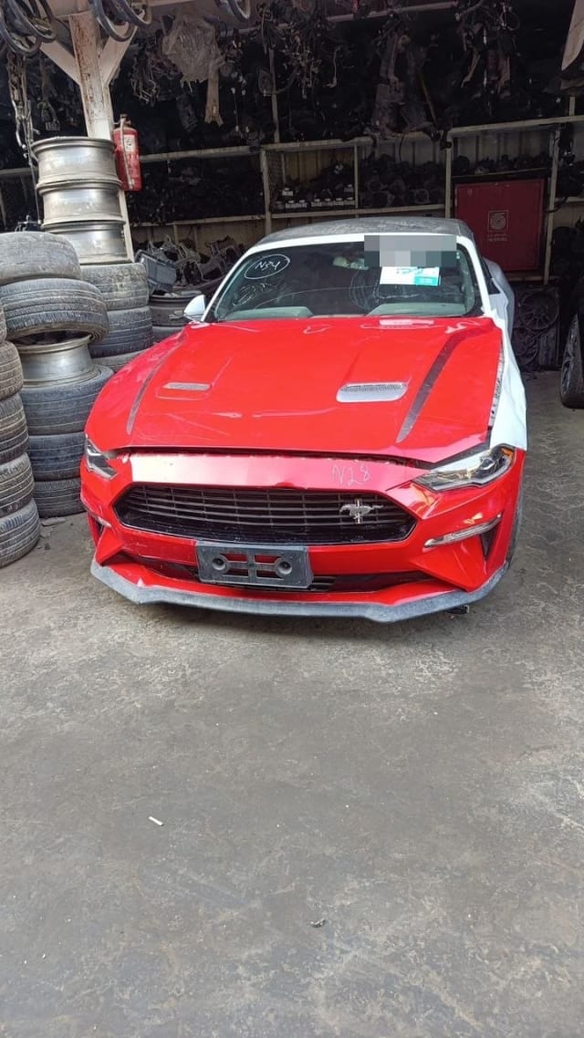 Red Ford Mustang coupe car for parts — vented hood, front bumper, grille and headlights, Sharjah market