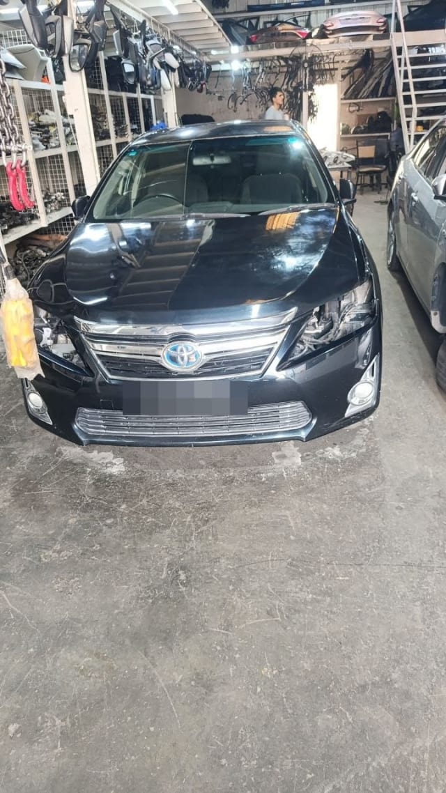 Black Toyota Camry sedan halfcut front view with hood, chrome grille and bumper, headlights removed, Sharjah market