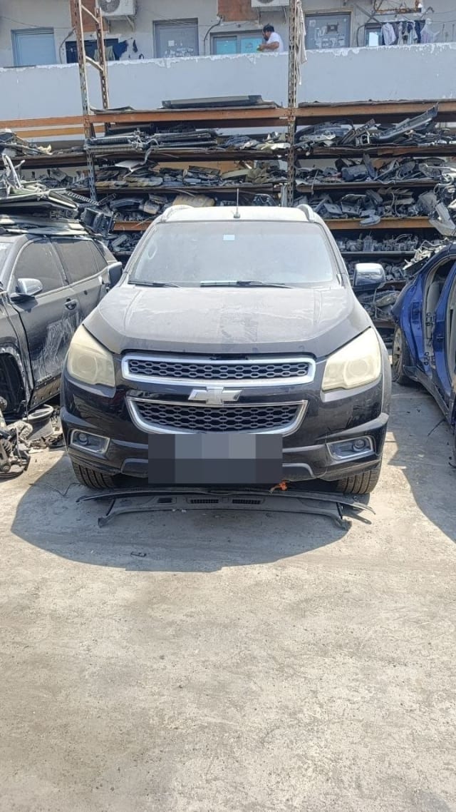 Black Chevrolet TrailBlazer SUV halfcut front view — hood, chrome grille, headlights and bumper, Sharjah market