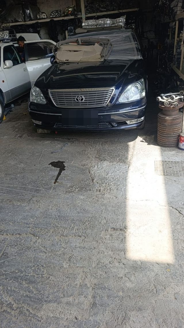 Dark blue Toyota Celsior sedan for parts, front view with grille, headlights and bumper, Sharjah market