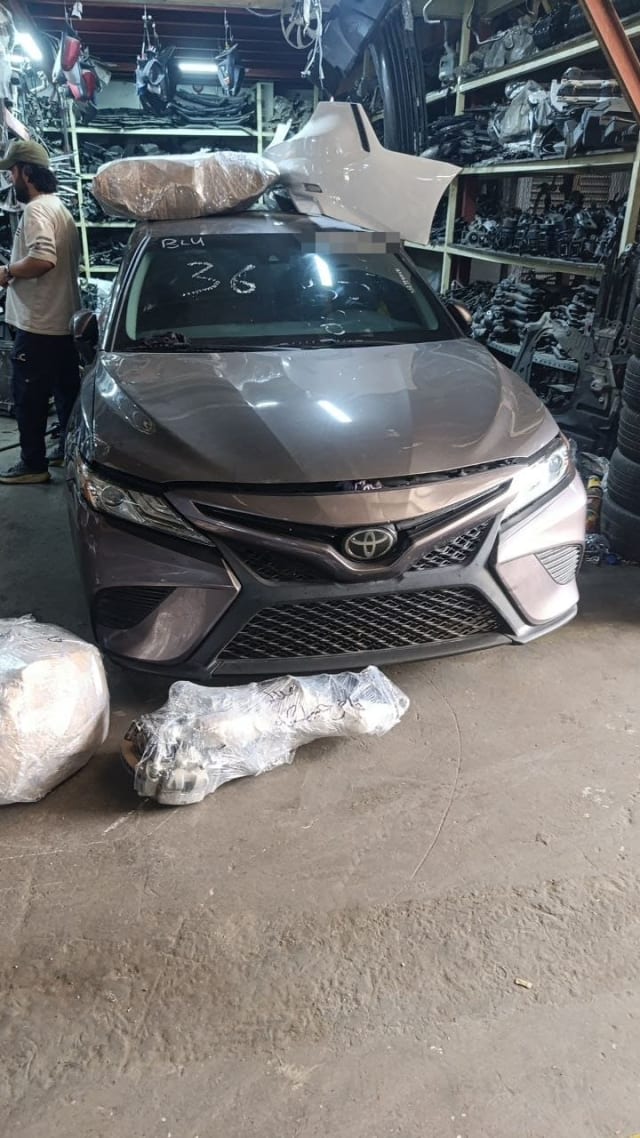 Grey Toyota Camry halfcut front: hood, bumper, mesh grille and headlights, Sharjah market