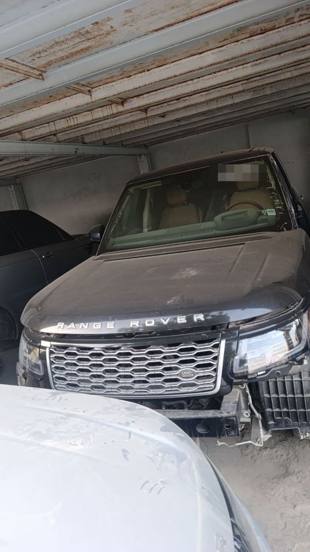 Black Land Rover Range Rover car for parts — hood, grille, LED headlights, bumper removed, Sharjah market