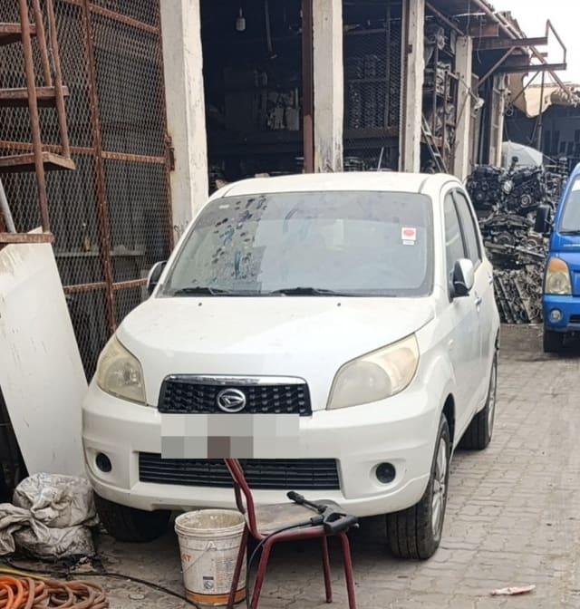 White Daihatsu Terios SUV for parts, front view: bumper, grille, headlights, hood, Sharjah market