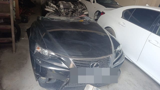 Black Lexus IS sedan halfcut with bumper, spindle grille, headlights and hood, Sharjah market