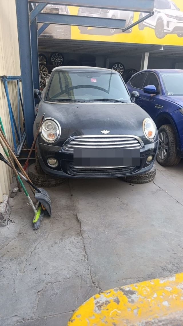 Black MINI Cooper hatchback for parts — front view with hood, grille, headlights and bumper, Sharjah market