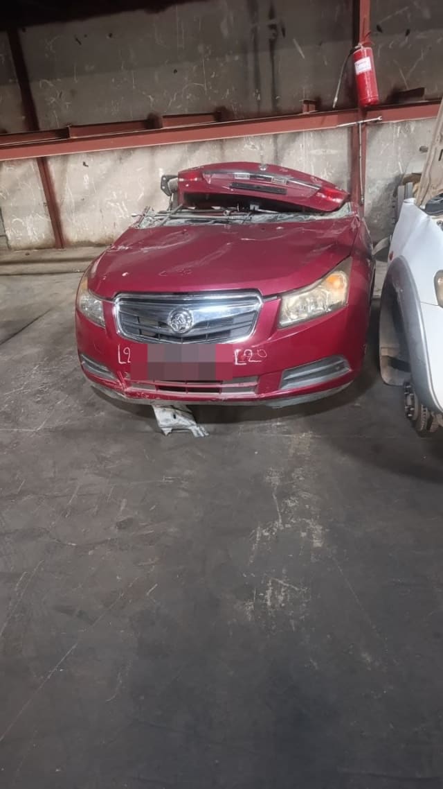 Red Holden Cruze sedan front halfcut — bumper, grille, headlights and hood, Sharjah market