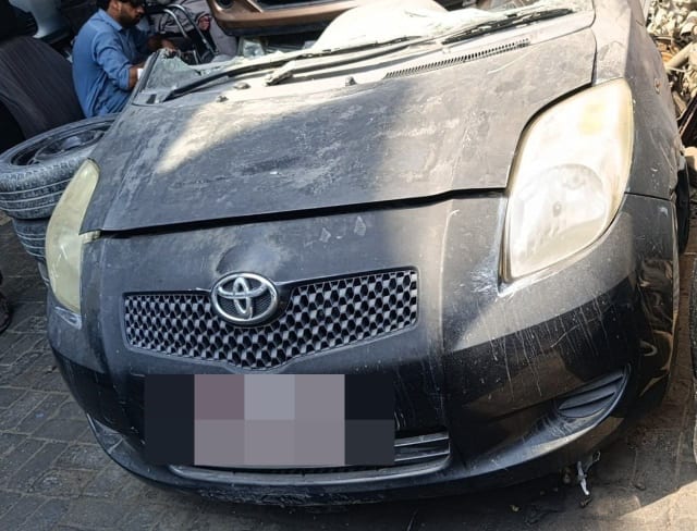 Black Toyota Yaris hatchback halfcut front: bumper, grille and headlights, Sharjah market