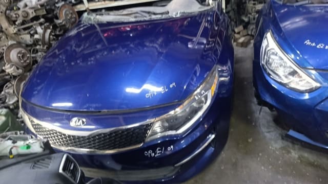 Blue Kia Optima sedan halfcut front — hood, grille, bumper and headlight, Sharjah market