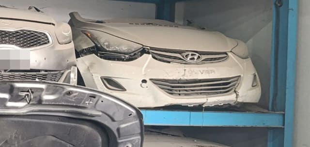 White Hyundai Elantra front halfcut on shelf with bumper, grille, headlight and hood, Sharjah market