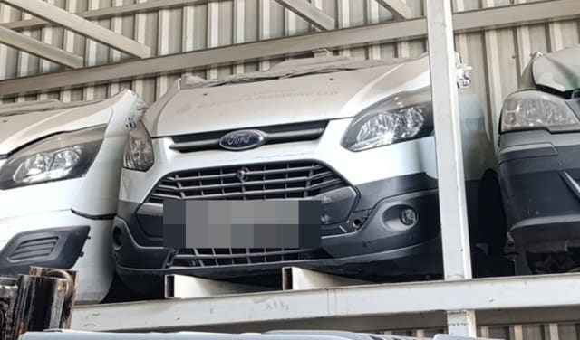 White Ford Transit Custom front halfcut on rack — hood, grille, headlights and bumper, Sharjah market