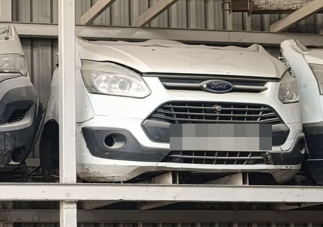 White Ford Transit Custom van front halfcut: bumper, grille, headlights and hood on a rack, Sharjah market