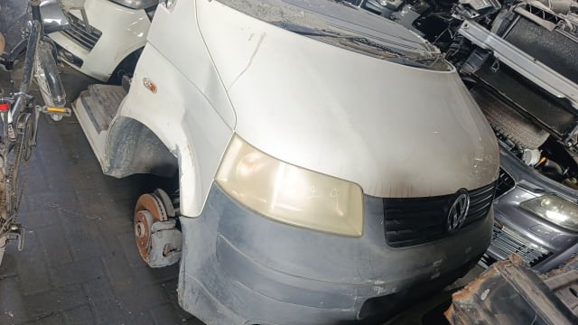 White VW Transporter van halfcut: hood, front bumper, grille, headlight, fender and brake disc, Sharjah market