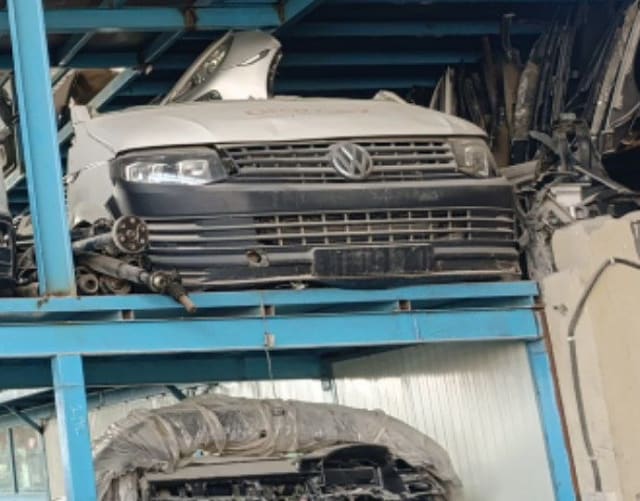 Silver Volkswagen Transporter front halfcut on blue rack — hood, headlights, grille and bumper, Sharjah market