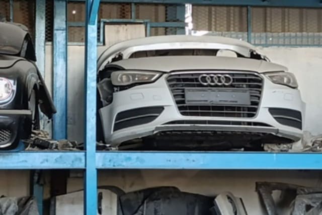 White Audi A3 front halfcut on shelf — bumper, grille, headlights and hood, Sharjah market
