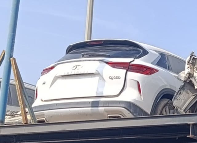 White Infiniti QX50 SUV rear view — tailgate, tail lights, spoiler and rear bumper, Sharjah market