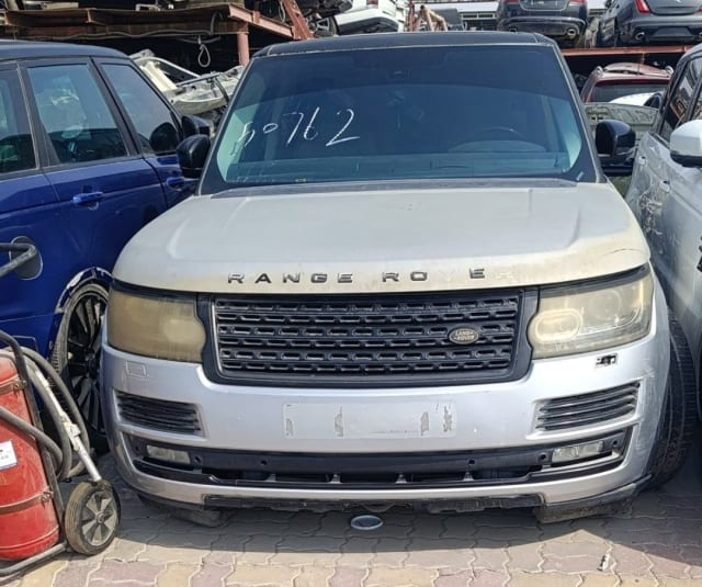 Silver Land Rover Range Rover SUV for parts — front view of hood, grille, headlights and bumper, Sharjah market