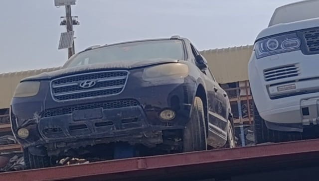 Dark Hyundai Santa Fe SUV for parts: grille, headlights, hood and front bumper, Sharjah market