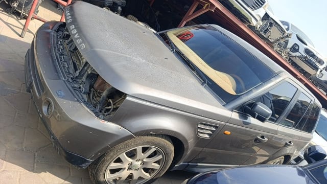 Dark grey Range Rover Sport car for parts — open hood, front bumper, fender and doors, Sharjah market