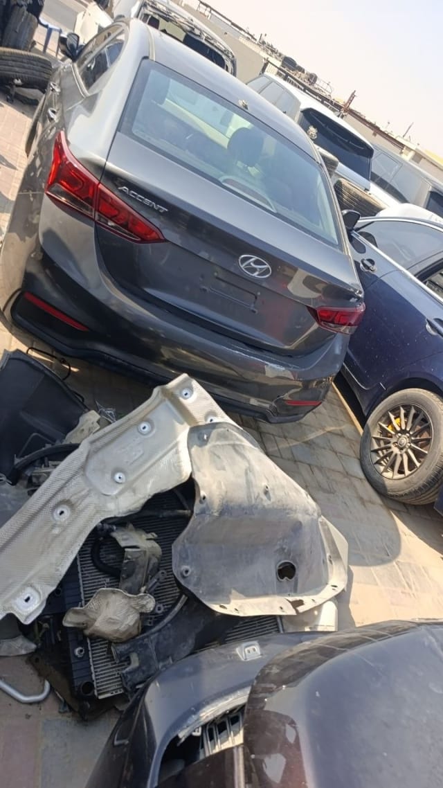 Dark grey Hyundai Accent sedan for parts — rear view, tail lights, trunk and radiator, Sharjah market