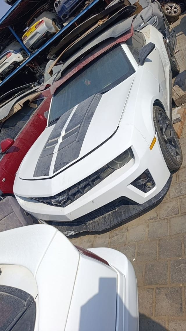 White Chevrolet Camaro coupe for parts with hood stripes, bumper, grille and headlights, Sharjah market