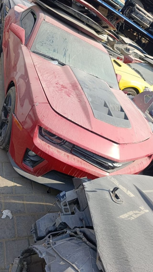 Dusty red Chevrolet Camaro coupe for parts — vented hood, headlights and front bumper, Sharjah market