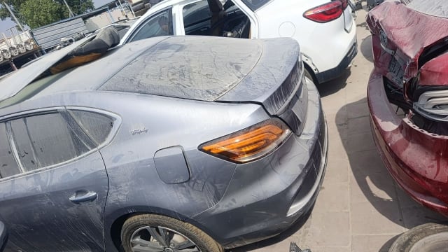 Grey MG MG6 liftback for parts, rear quarter view with tailgate, tail light and rear bumper, Sharjah market
