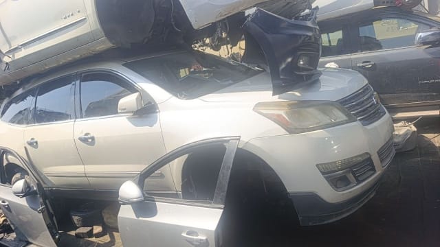 White Chevrolet Traverse SUV for parts — bumper, grille, headlights, hood and doors, Sharjah market