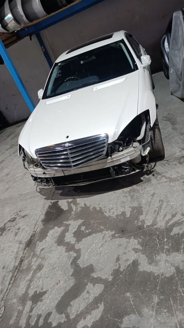 White Mercedes-Benz S-Class car for parts — hood, chrome grille, fenders, bumper removed, Sharjah market