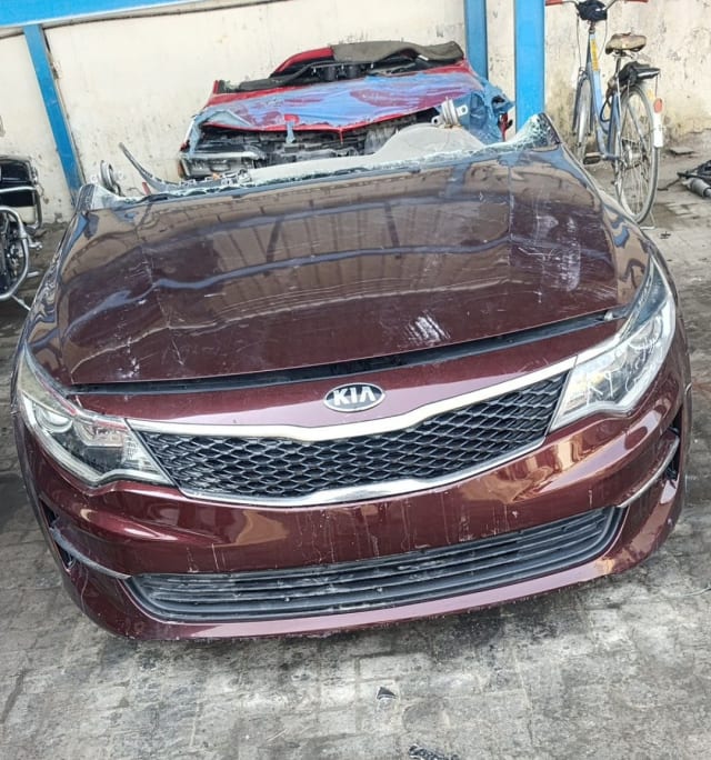 Maroon Kia Optima front halfcut with hood, grille, bumper and headlights, Sharjah market
