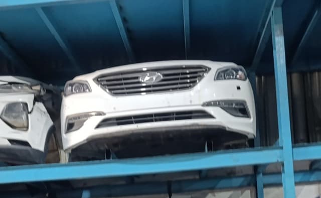 White Hyundai Sonata front halfcut, bumper, grille and headlights on blue rack, Sharjah market