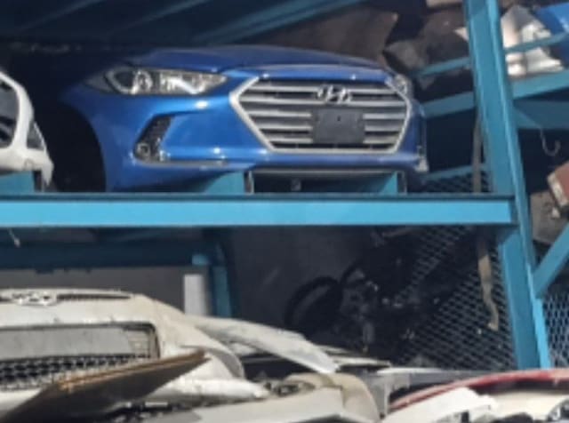 Blue Hyundai Elantra front halfcut on rack: bumper, grille and headlights, Sharjah market