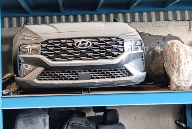 Grey Hyundai Santa Fe front halfcut on rack — hood, grille, headlights and bumper, Sharjah market