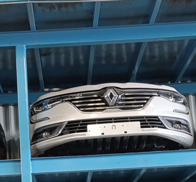 White Renault Talisman front cut on rack — bumper, chrome grille and headlights, Sharjah market