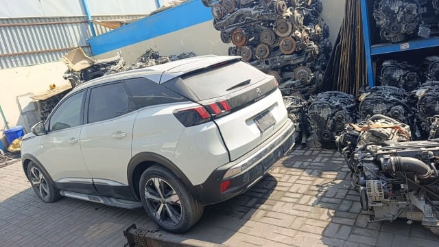 White Peugeot 3008 SUV for parts, rear view with tailgate, tail lights and alloy wheels, Sharjah market