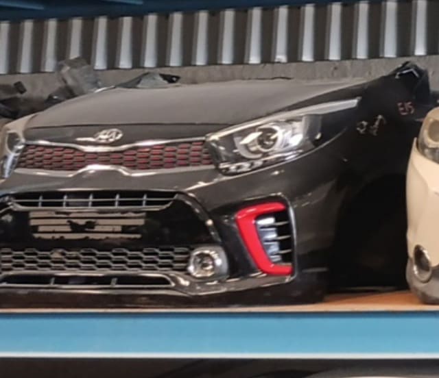 Dark grey Kia Picanto front halfcut with hood, red-accent grille, bumper and headlight, Sharjah market
