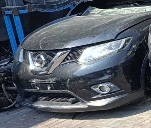 Black Nissan X-Trail front halfcut: hood, chrome grille, headlight and bumper with fog light, Sharjah market