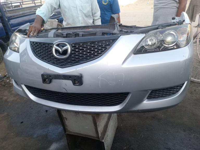 Mazda 3 Front Bumper with Grille and Headlights (x2)