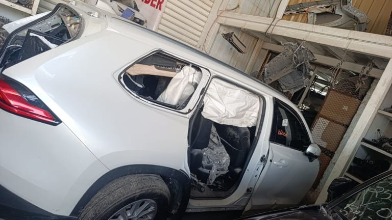 White Toyota RAV4 side halfcut — doors, wing mirror, tail light and alloy wheel, Sharjah market