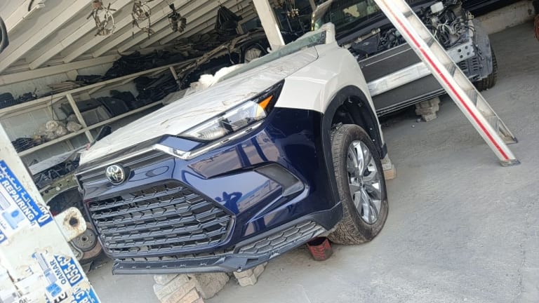 Blue and white Toyota RAV4 front halfcut — bumper, grille, headlight and alloy wheel, Sharjah market
