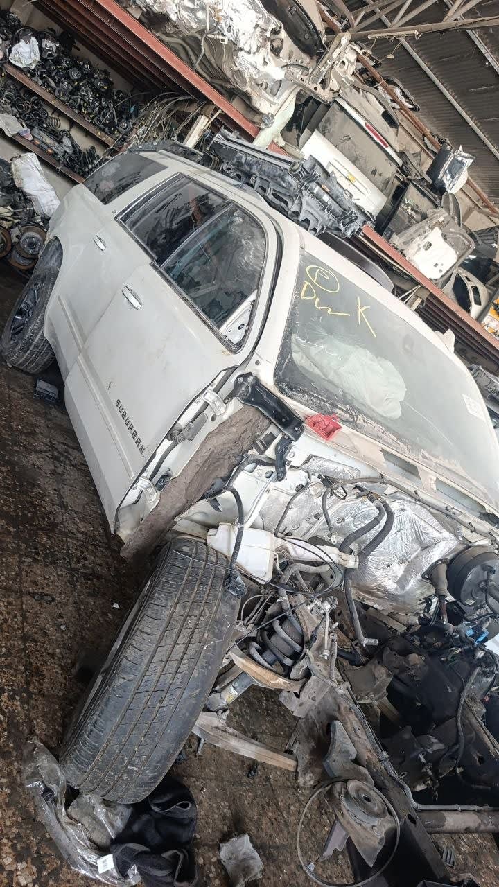 White Chevrolet Suburban SUV halfcut — doors, glass, wheel and exposed engine bay, Sharjah market