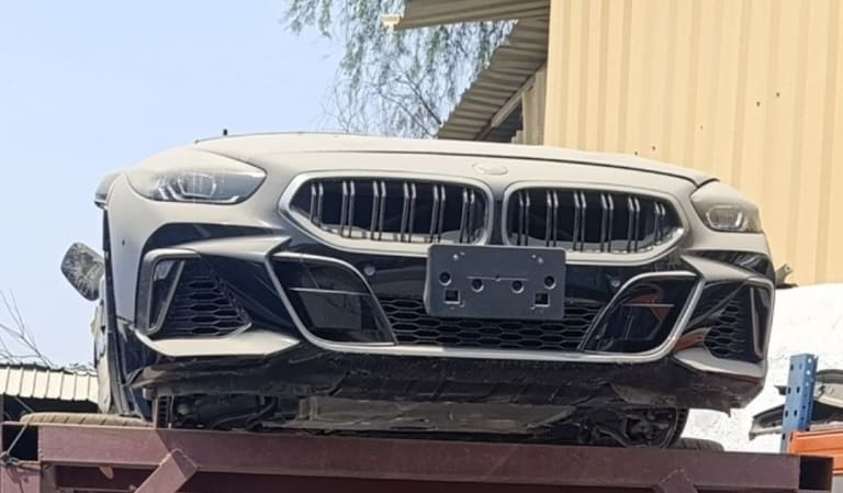 Black BMW 8-Series coupe front halfcut — bumper, kidney grille and headlights, Sharjah market