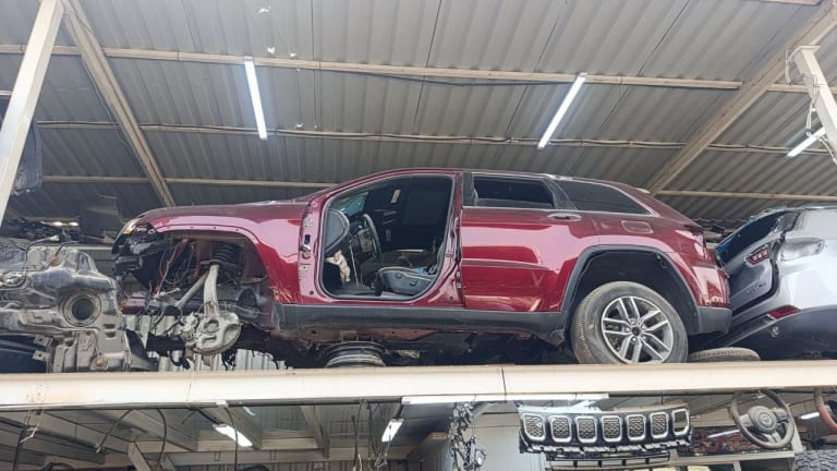 Dark red Jeep Grand Cherokee SUV halfcut — rear cabin, doors, roof and alloy wheel, Sharjah market